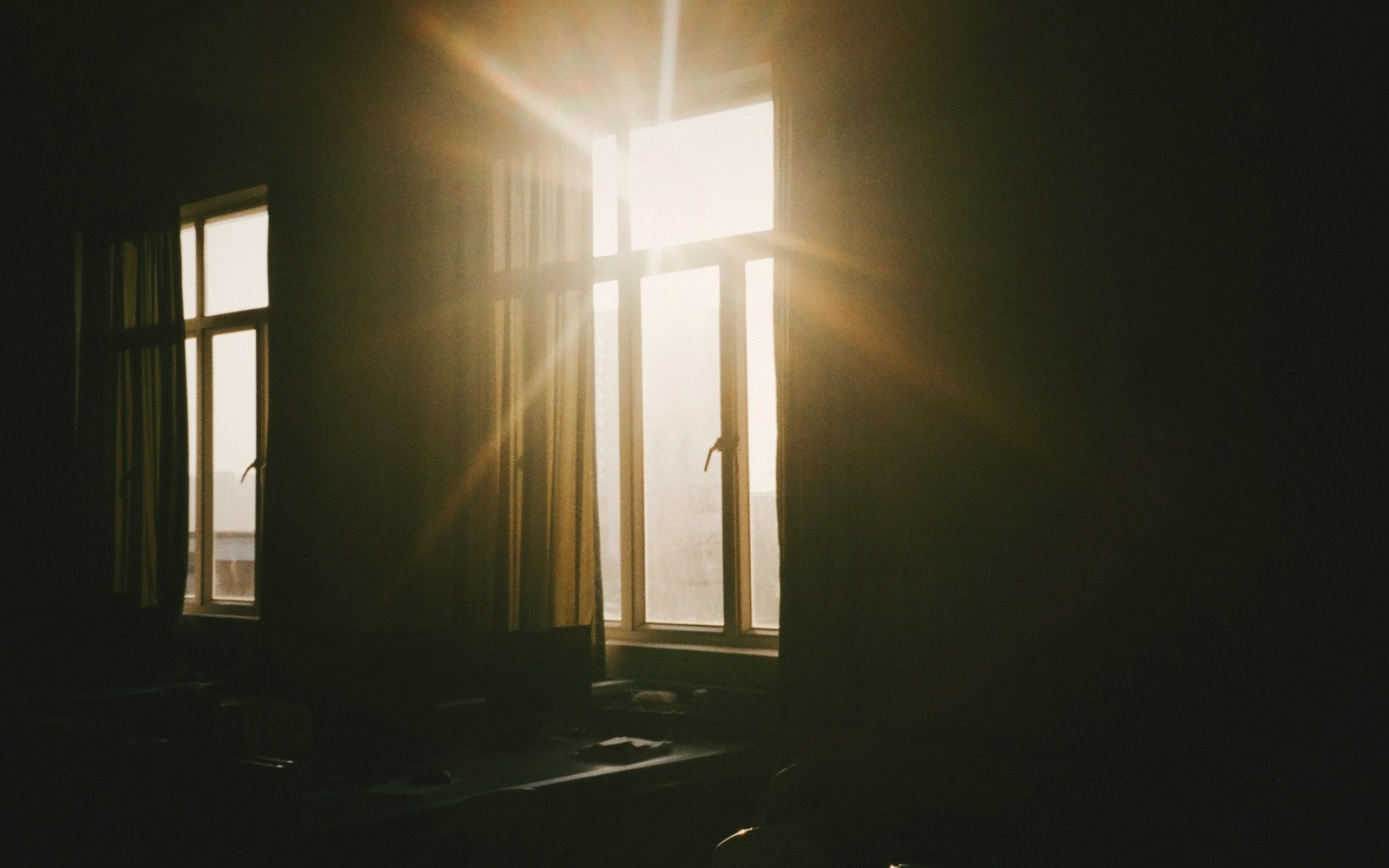 A reading chair by a window in low afternoon sun